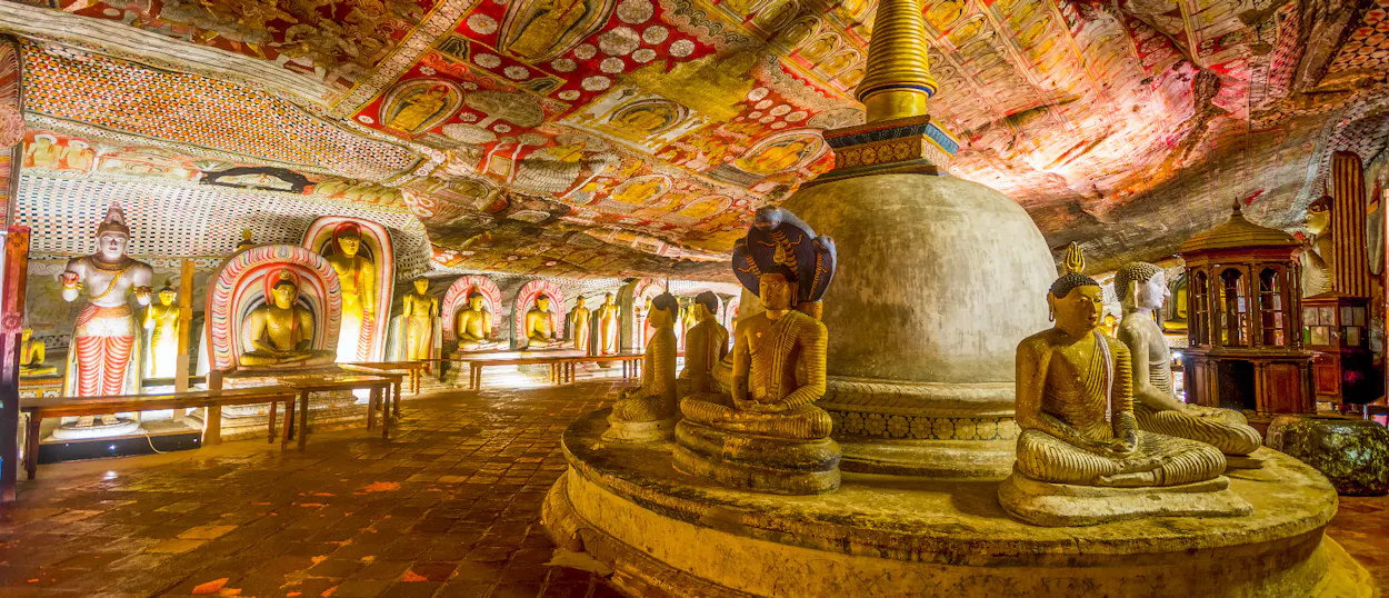 The ancient Dambulla Cave Temple in Sri Lanka, filled with many Buddha statues and vibrant frescoes.