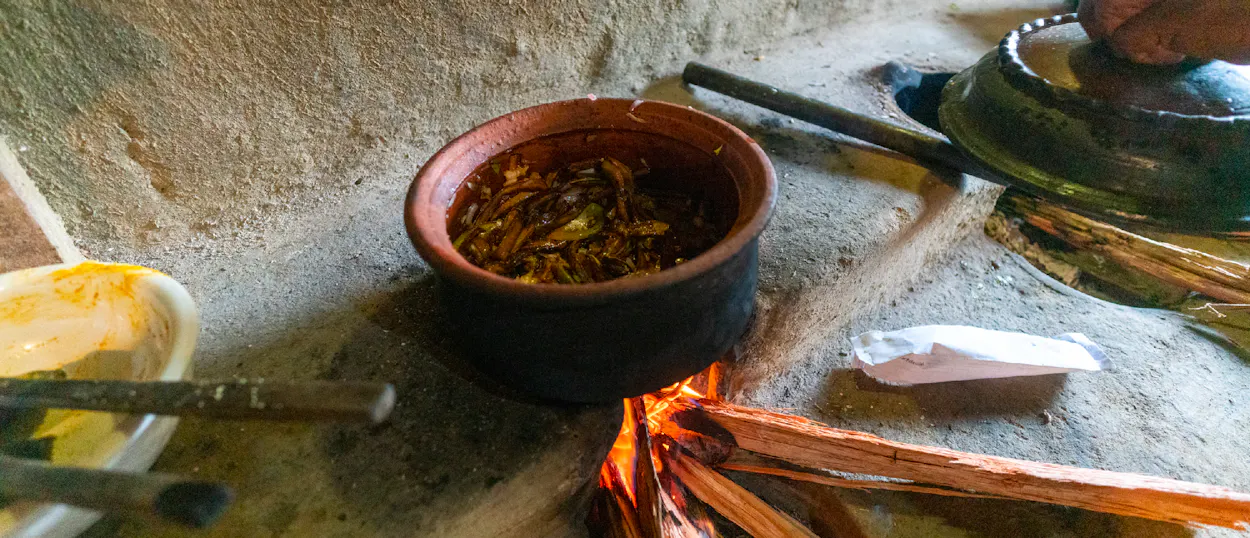 Traditional Sri Lankan curry simmers in a clay pot over an open wood fire in Ella.