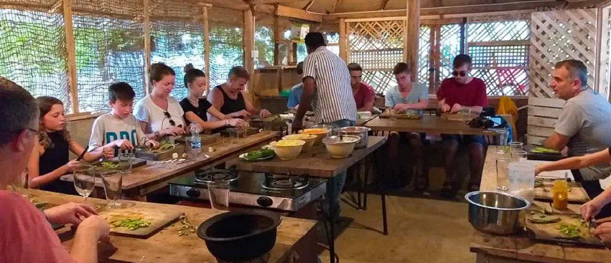 Backpackers learn to prepare Sri Lankan dishes during a hands-on cooking class with a local in Ella.