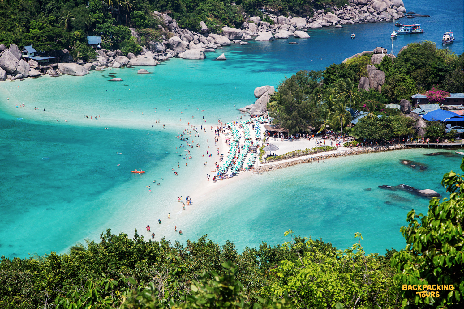Panoramic view of Koh Nangyuan's iconic sandbar beach, bustling with people enjoying the turquoise waters.