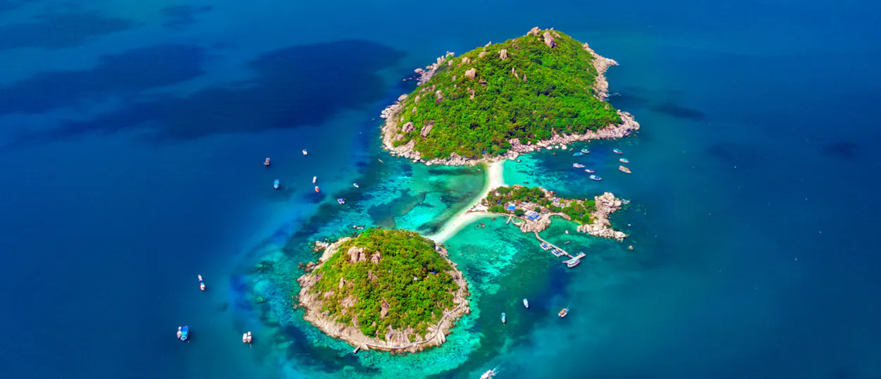 Koh Nangyuan's iconic three islands connected by a pristine white sandbar, surrounded by turquoise waters.