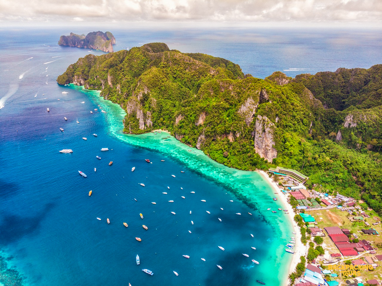 Aerial view of Phi Phi islands with turquoise waters and limestone cliffs during the backpacking tour boat trip
