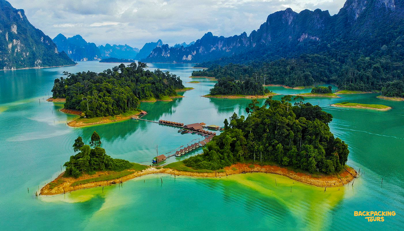 Aerial view of Cheow Lan Lake in Khao Sok National Park with emerald water and limestone cliffs