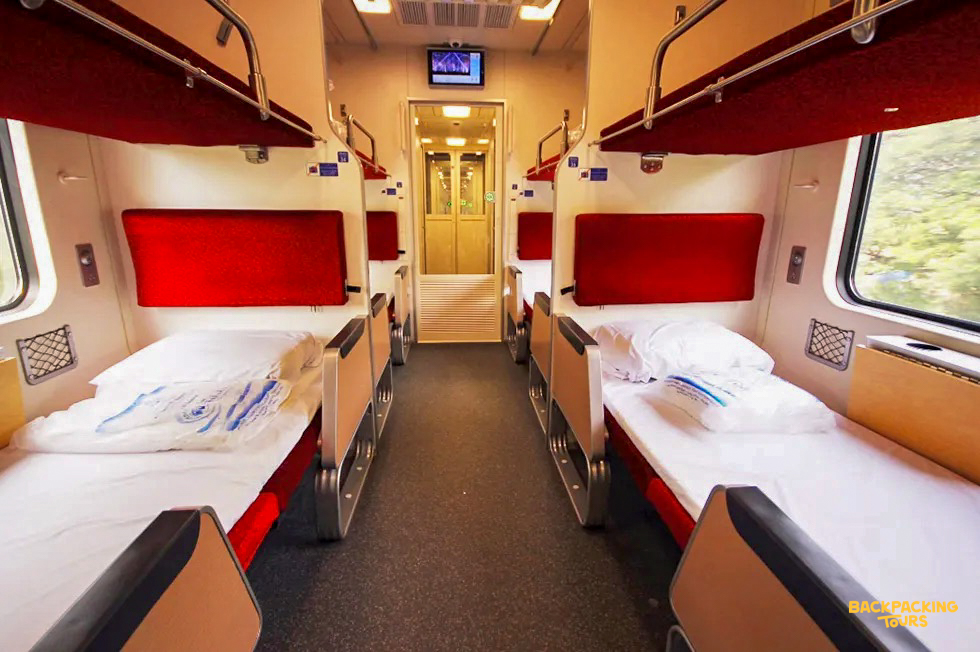 A comfortable sleeper cabin on a Thai train, with bunk beds ready for an overnight journey.