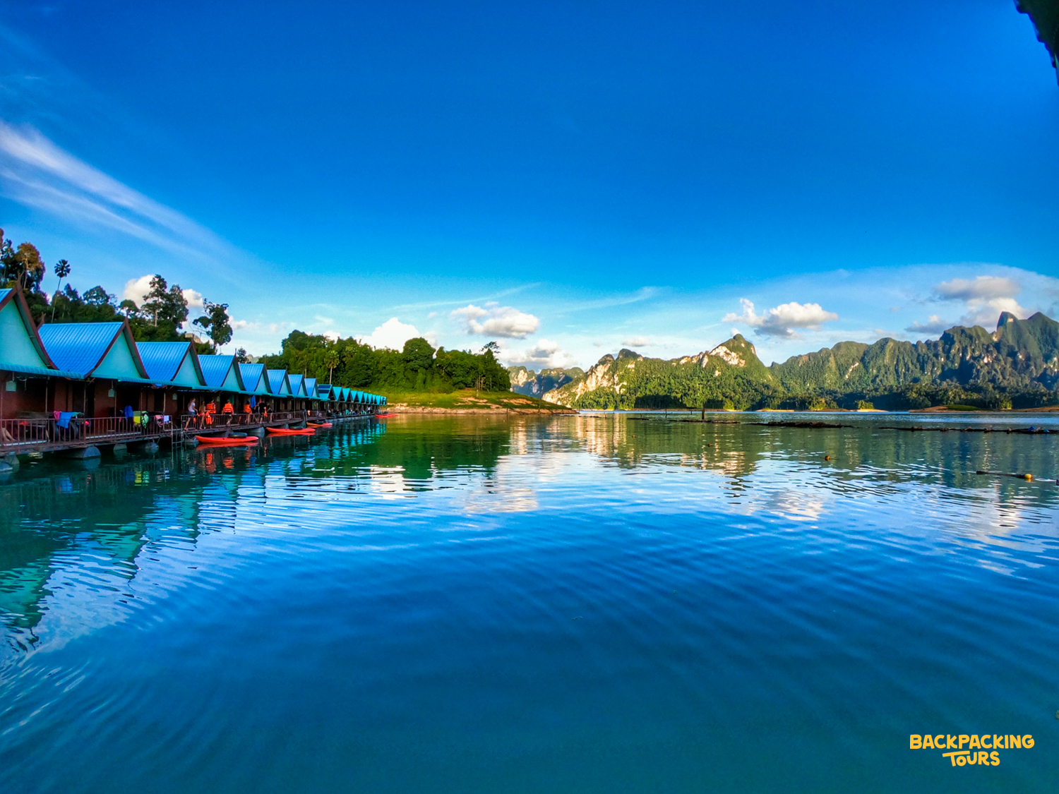 Guests enjoy floating bungalows on Cheow Lan Lake, Khao Sok National Park, surrounded by limestone karsts.