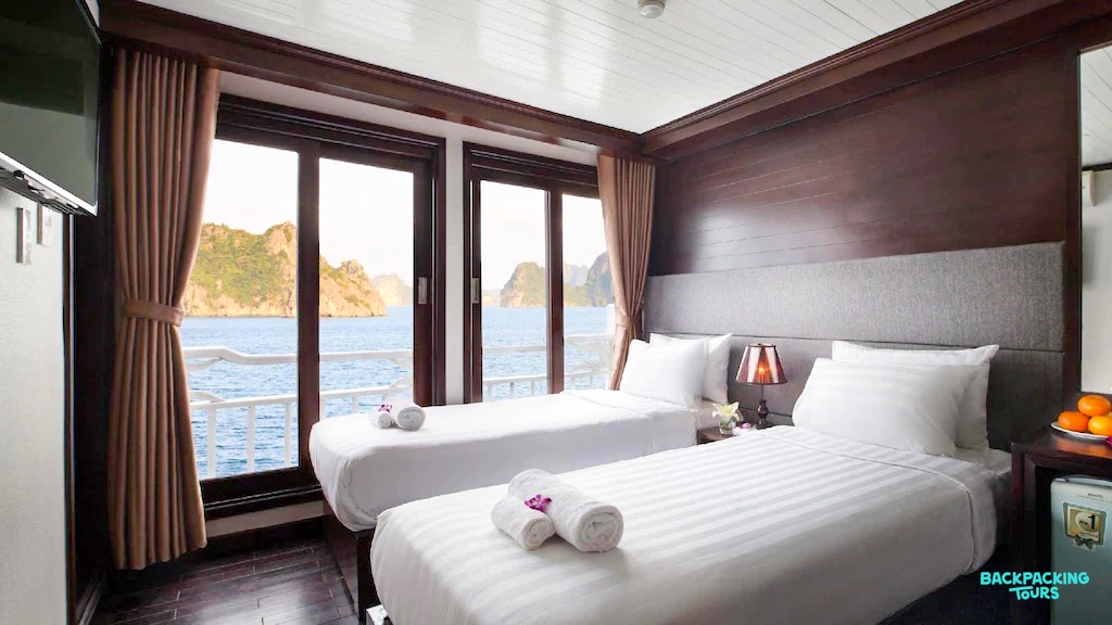 A comfortable twin-bed cabin on an overnight boat, offering scenic views of Ha Long Bay.